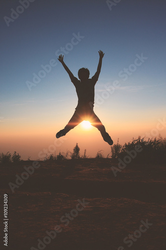 Man jumps in the sunset.