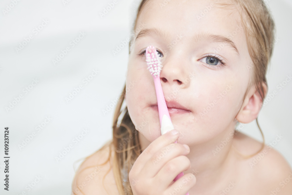 Dental hygiene. Close up of little girl brushing her teeth. Fun in the bath Dental hygiene. Close up of little girl brushing her teeth. Fun in the bath