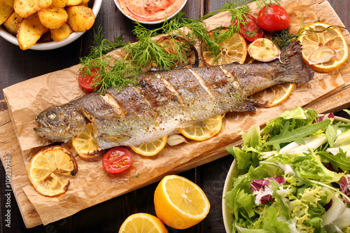 Baked fish with roasted potatoes and salad