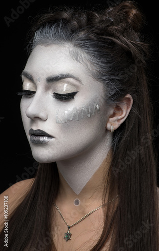 Closeup portrait of woman with white make up ..