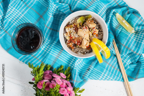 Cooked funchoza with chicken fillet and toasted sesame seeds photo