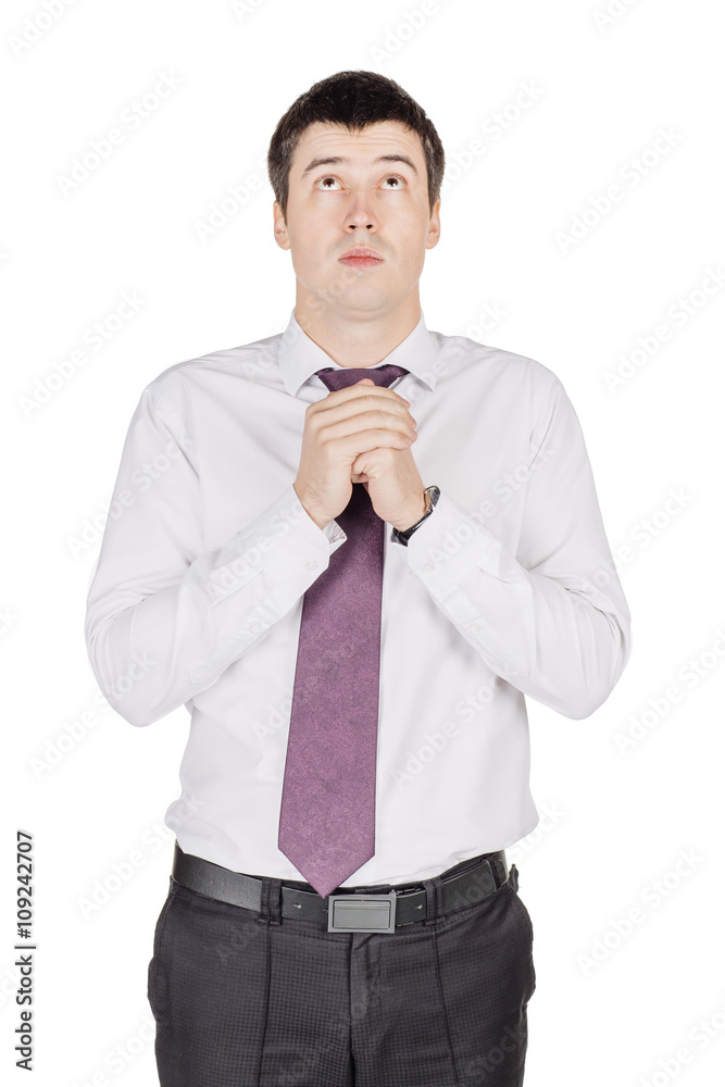 Portrait of young smiling business man praying. image isolated over white background Portrait of young smiling business man praying. image isolated over white background