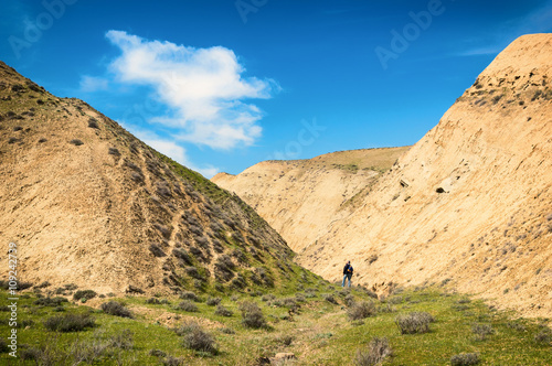 Clay mountains. Mountaineer in the background photo