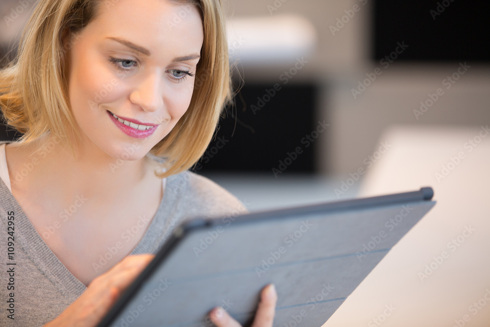 Portrait of a smiling woman using a touchpad Portrait of a smiling woman using a touchpad
