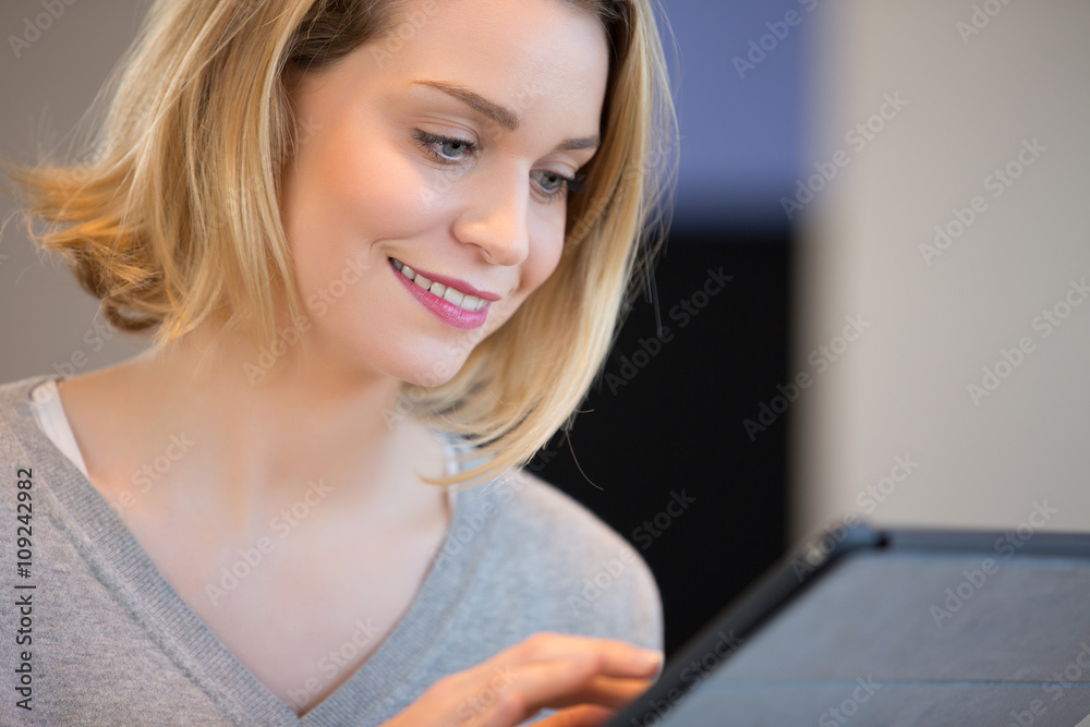 Portrait of a smiling woman using a touchpad Portrait of a smiling woman using a touchpad
