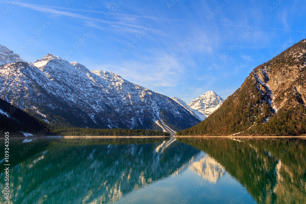 Plansee lake spring panorama with snow on mount top, Tyrol, Austria.