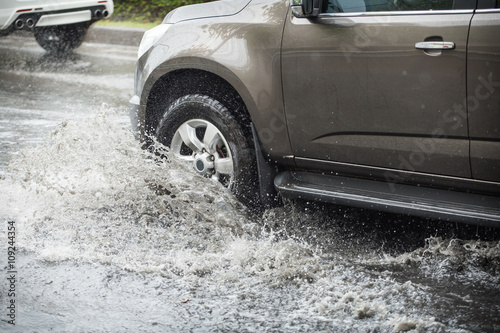 Splash by a car as it goes through flood water