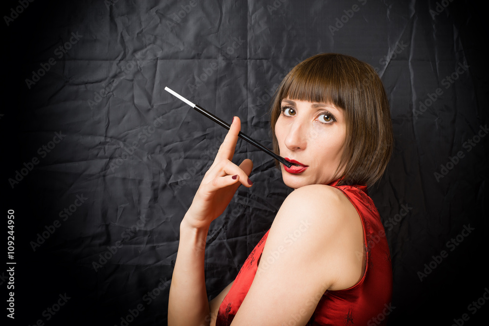 Fototapeta premium woman with a cigarette holder
