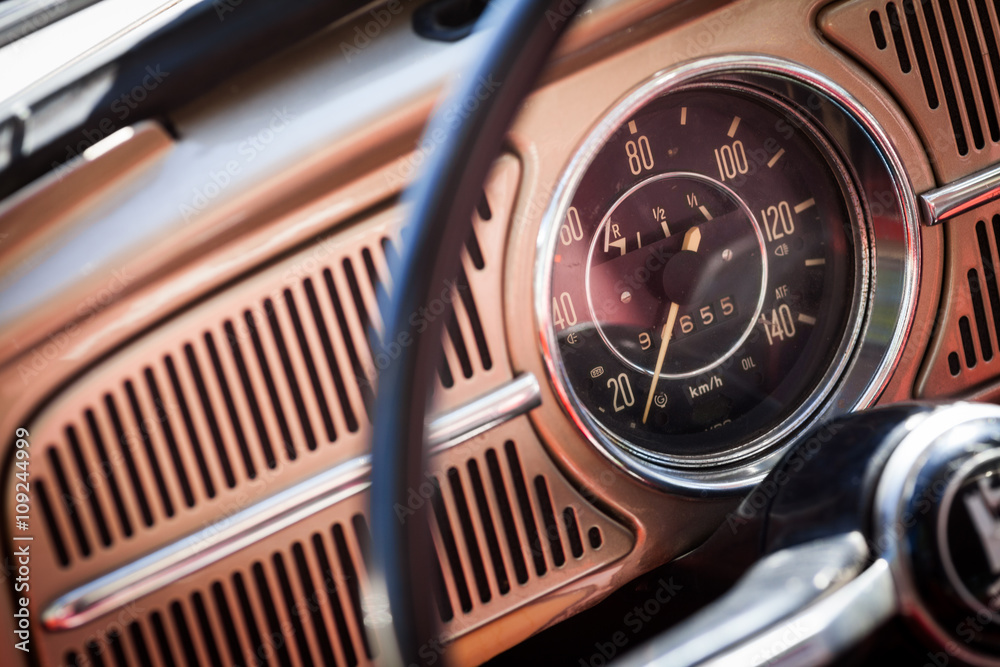 Color image of the dashboard of a retro car.