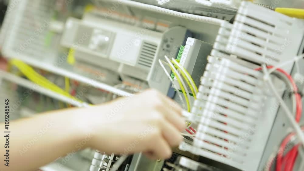 Hands wiring an electronics circuit board in a factory Hands wiring an electronics circuit board in a factory