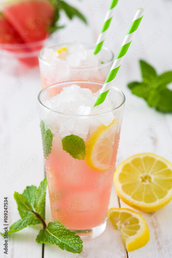 Fototapeta premium Fresh watermelon mojito on white wooden table 
