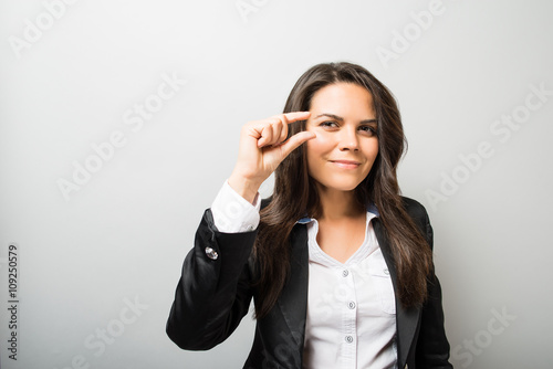 Photos young woman showing a little