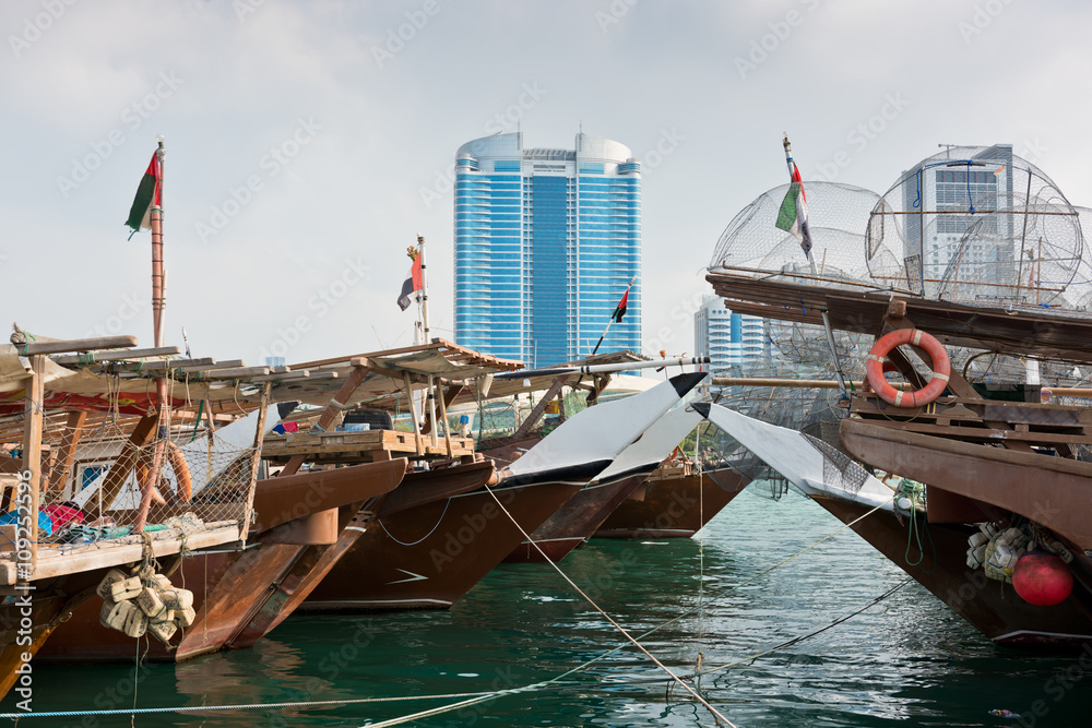 Abu Dhabi buildings skyline with old fishing boats