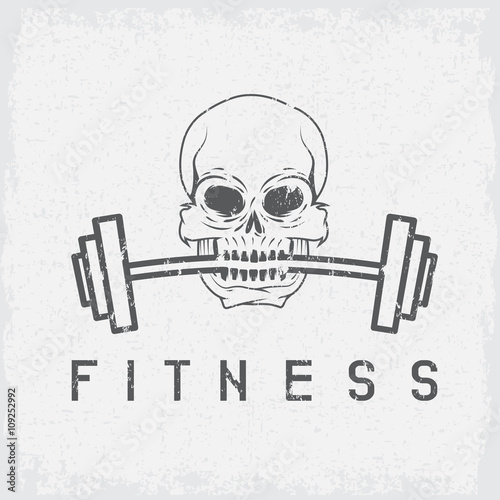 skull holding barbell in the teeth grunge fitness concept
