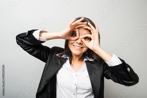 business woman looking through the hands of binoculars