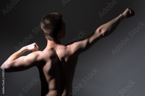 Muscular man shows back