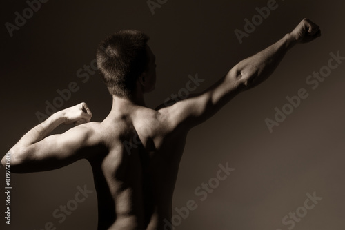 Muscular man shows back