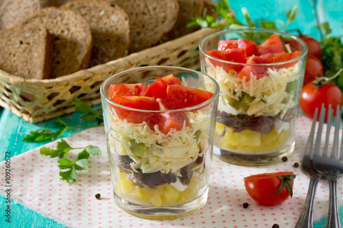 Salad with meat, cheese and vegetables (potatoes, pickled cucumb