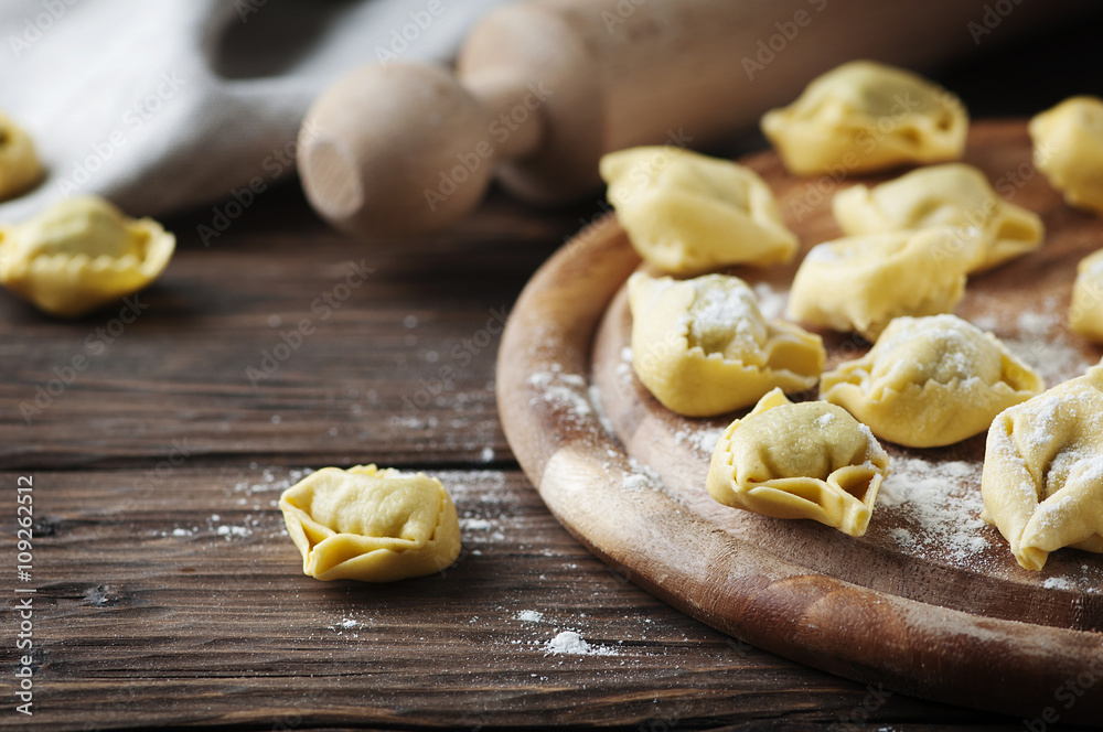 Italian traditional tortellini on the wooden table Italian traditional tortellini on the wooden table