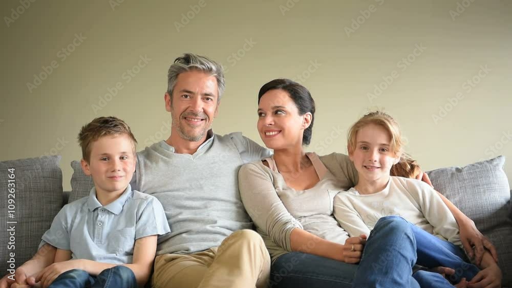 Portrait of happy family sitting in sofa Portrait of happy family sitting in sofa