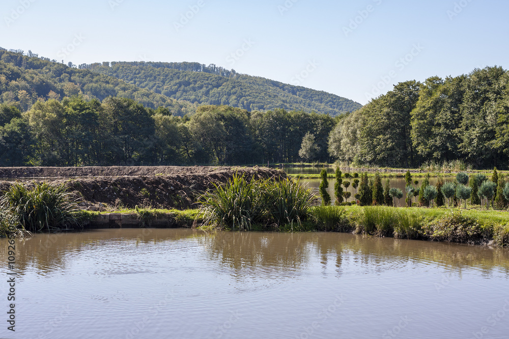 Fototapeta premium picture of artificial lake surrounded by natural landscape