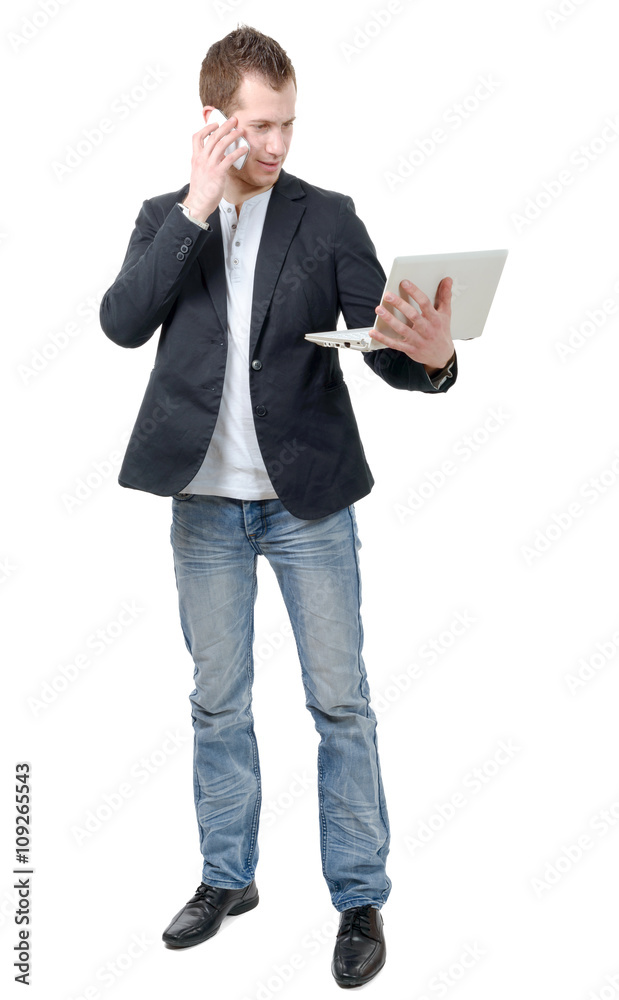 young man standing with laptop and phone young man standing with laptop and phone