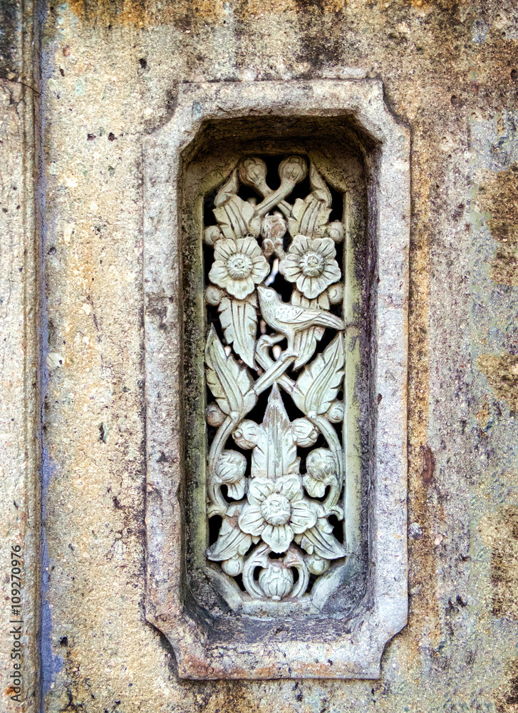 Classical Thai decorative vintage ornament on stone wall.
