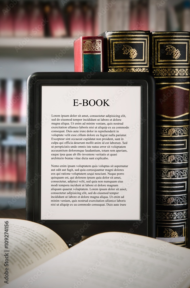 Fototapeta premium E-book reader device on desk in library