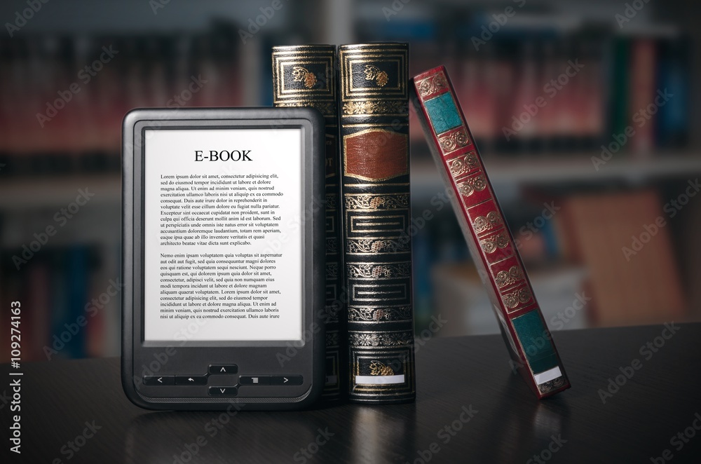 Obraz premium E-book reader device on desk in library