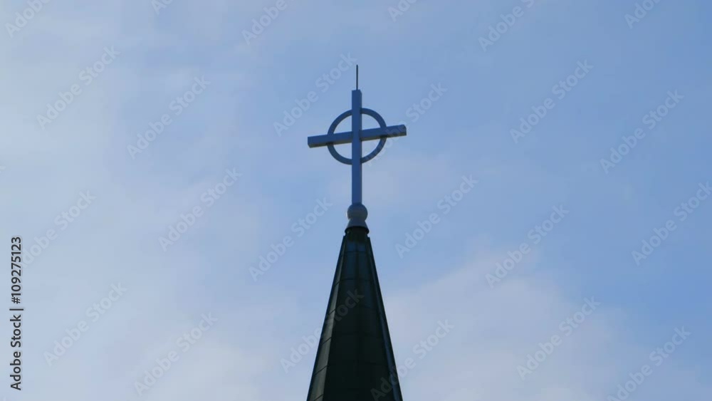 Church spire with cross against a blue sky Church spire with cross against a blue sky