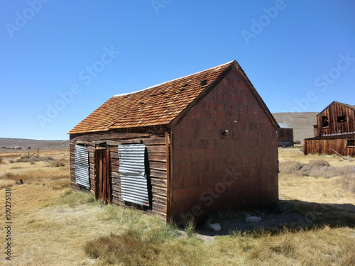 Abandoned wooden shack in Bodie  California national park - landscape color photo