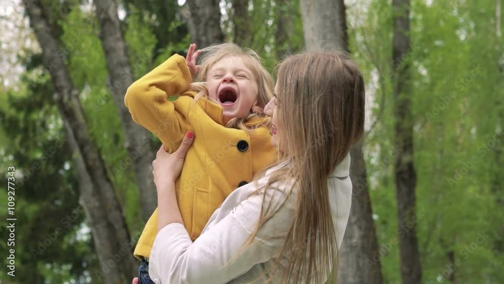 Happy mother with child on hands looking on camera. Slowly Happy mother with child on hands looking on camera. Slowly