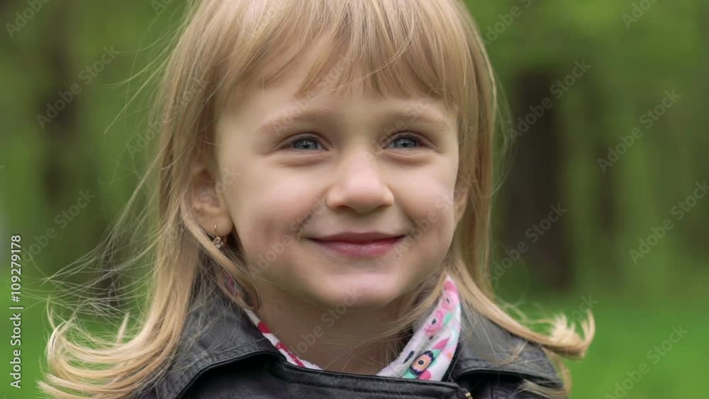Portrait of 3 years old girl smiling on a camera. Slowly Portrait of 3 years old girl smiling on a camera. Slowly