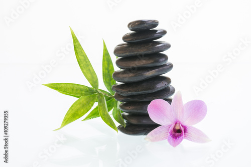 Fototapeta Naklejka Na Ścianę i Meble -  Black zen stones with Dendrobium orchid and bamboo leaves 