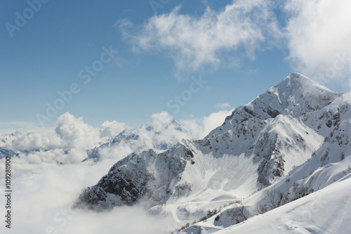 Winter mountain landscape and cloudy sky.