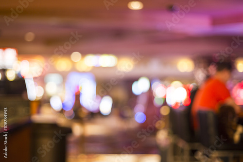 Blurry out of focus players on slot machines or a bar in a casino in Las Vegas, Nevada