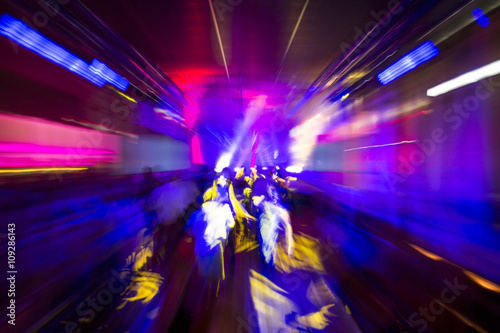 Colourful night club party lights in motion blur, abstract background design, people dancing drunk or on drugs