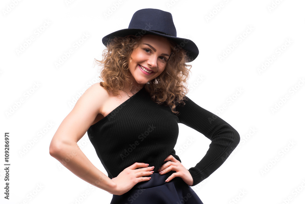 woman with curly hair in black hat and stylish elegant evening dress posing on white studio background. woman with curly hair in black hat and stylish elegant evening dress posing on white studio background.