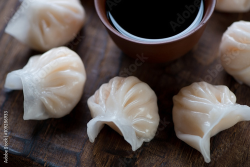 Close-up of steamed dim-sum dumplings and soy sauce, studio shot