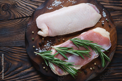 Closeup of raw fresh duck breast filet with condiments, top view