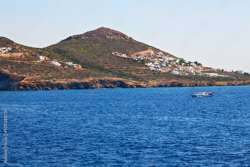 sailing  near hill and rocks  santorini island