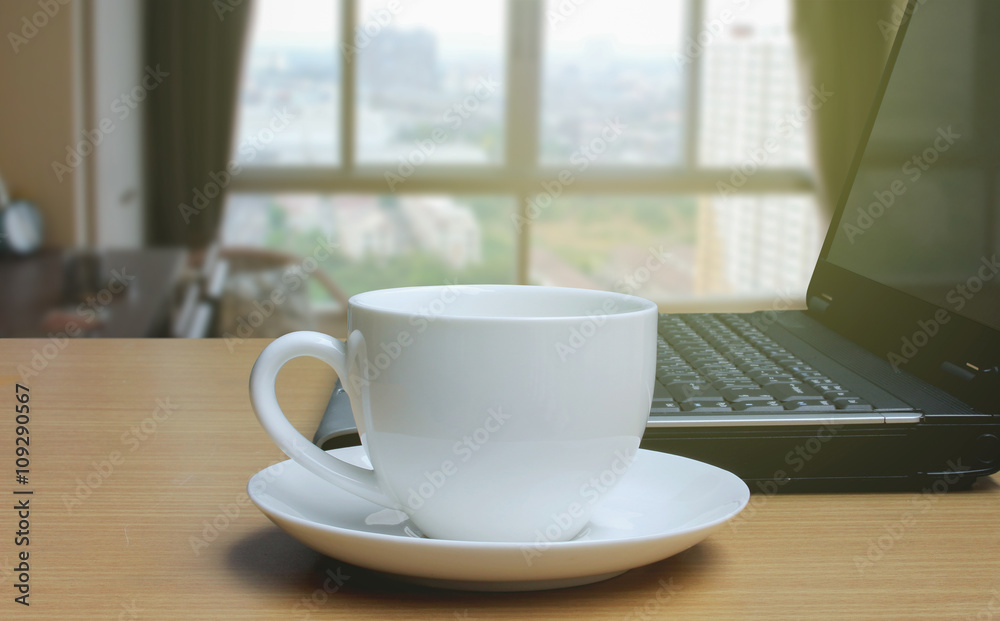 Cup of coffee on the wooden floor and Blurred bedroom window bac Cup of coffee on the wooden floor and Blurred bedroom window bac