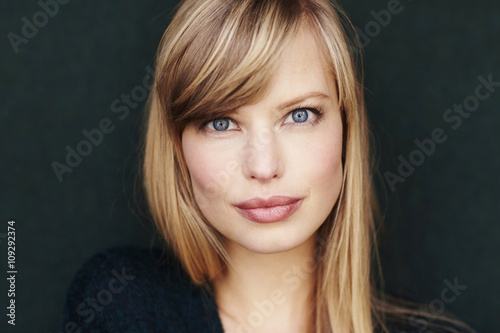 Blue eyes on blond woman looking at camera