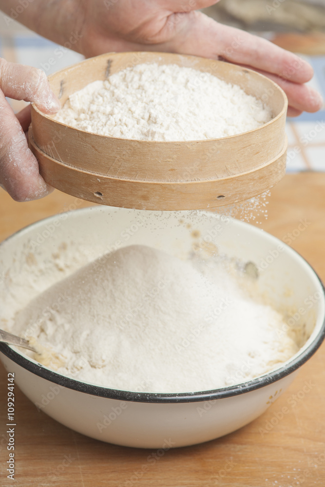 Women's hands preparing flour before baking pie