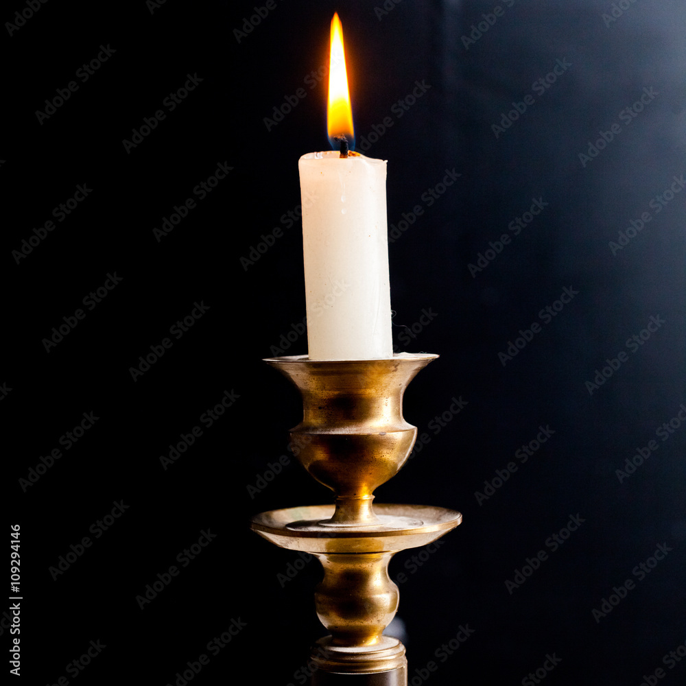 Retro style candle holder with lighted candle Retro style candle holder with lighted candle