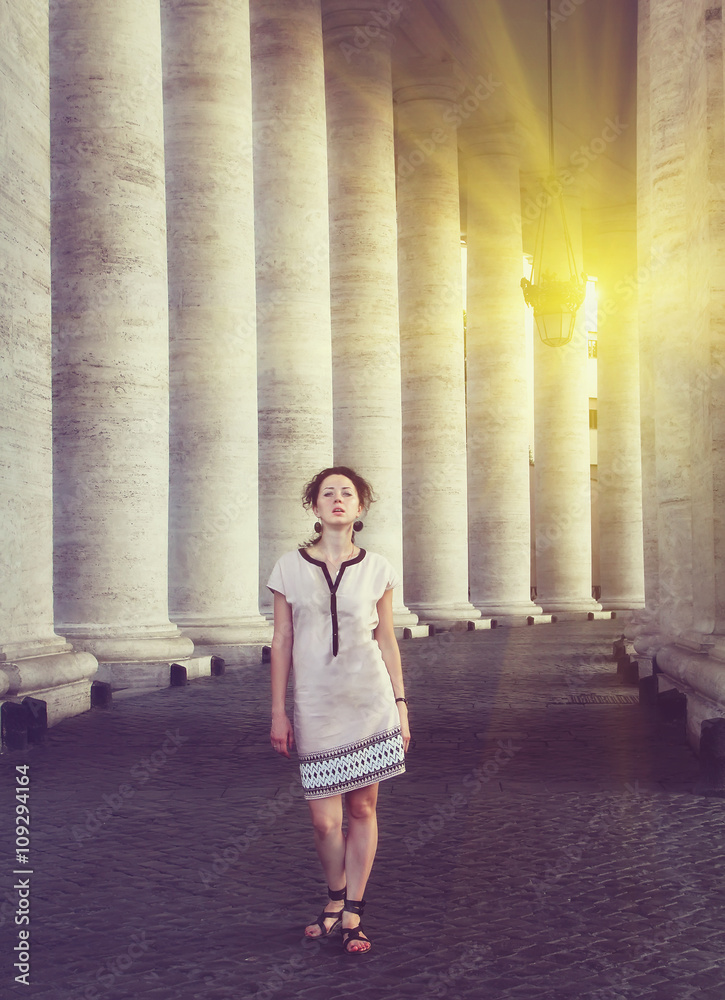 A beautiful young woman posing near St. Peter's square in Vatican, Rome. Vintage style picture