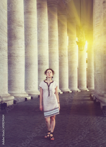 A beautiful young woman posing near St. Peter's square in Vatican, Rome. Vintage style picture © sergeialyoshin