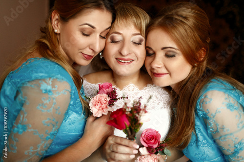 Happy beautiful bride with bridesmaids