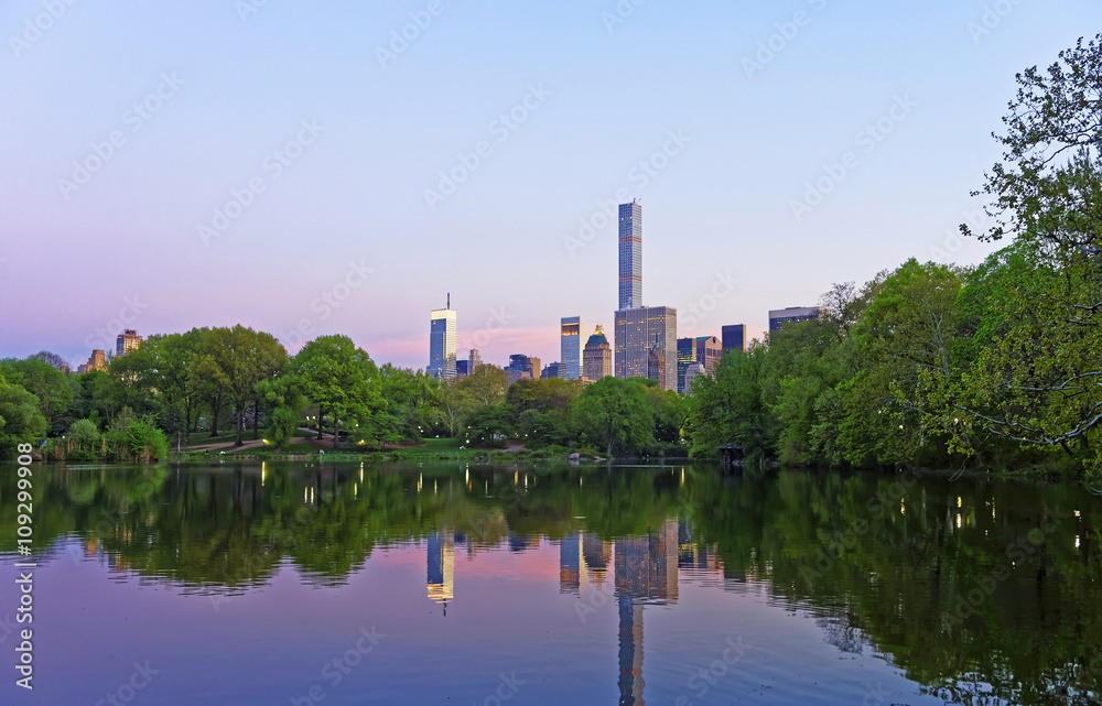 Manhattan mirrored from water in Central Park Manhattan mirrored from water in Central Park