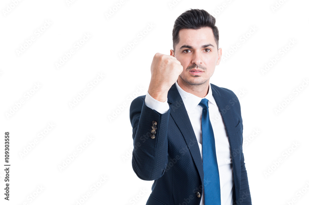 Handsome young manager threatening by showing the fist Handsome young manager threatening by showing the fist